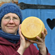 woman proudly holding cheese